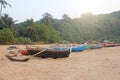 Bright colorful boats with flags for catching fish stood on the shore of the Indian Ocean. India, Goa