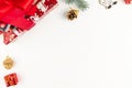 Colorful boxes tied with a red ribbon with gifts, golden cones and a Christmas tree branch on a background of white wood with gold Royalty Free Stock Photo
