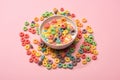 Bright colorful breakfast cereal with milk in bowl and around Royalty Free Stock Photo