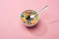 Bright colorful breakfast cereal with milk in bowl with spoon Royalty Free Stock Photo