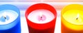 Bright colorful candles. Scented colorful candles with lighted wicks Royalty Free Stock Photo