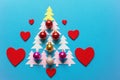 Bright colorful Christmas balls and red felt hearts. Paper fir-trees in the form of a Christmas tree. Copy space Royalty Free Stock Photo