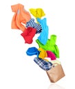 Bright colorful clothes flying out from paper package isolated on white background Royalty Free Stock Photo