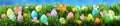 Bright colorful Easter eggs on green grass with flowers Royalty Free Stock Photo