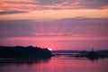 Bright, colorful evening landscape over the river Daugava of pink and purple tones. Dramatic sunset scenery Royalty Free Stock Photo