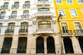 Bright colorful facade of old European building with windows .