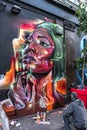 Bright colorful female face graffiti.