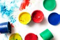 Bright colorful finger paint pots with paint prints