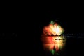 Beautiful colorful fireworks display on the urban lake for celebration on dark night background Royalty Free Stock Photo