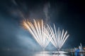 Beautiful colorful fireworks display on the urban lake for celebration on dark night background Royalty Free Stock Photo