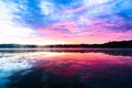 Bright colorful foggy sunset on the lake with clouds and reflections in Finland. Nature amazing sunrise background. Royalty Free Stock Photo