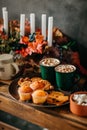 Bright and colorful food photo, tasty orange cakes, holiday decoration. Cocoa with marshmallow Royalty Free Stock Photo