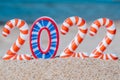 Bright, colorful, funny striped numbers of 2022 against the background of a sandy beach and the sea. Creative Christmas card. Royalty Free Stock Photo