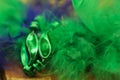 Colorful green and purple blurred Mardi Gras background with feathers and beads Royalty Free Stock Photo