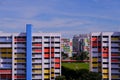 Bright colorful HDB flats buildings in Singapore, against cloudy blue sky Royalty Free Stock Photo