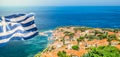 Greece National Flag on top of the castle of Molyvos. Aerial view of Mithymna town. Royalty Free Stock Photo