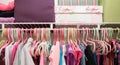 Bright and colorful neatly organized girl`s closet.