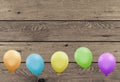 Bright colorful party balloons with wooden planks board