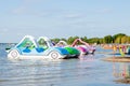 Bright colorful pedal boats at the lake beach