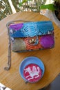 bright colorful python bag with pink beetroot latte on wooden background.