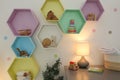 Colorful shelves on light wall in room. Interior design