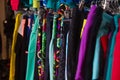 Bright colorful sports pants hanging on a rack in shop