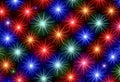 Bright colorful starburst shapes in red blue and green form diagonal rows on a dark background creating a festive abstract pattern Royalty Free Stock Photo