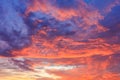Bright colorful sunrise sky backgroud. Vibrant fire dramatic blue, red and yellow tones.