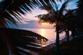 Bright colorful sunset on the shore of a tropical sea, silhouettes of palm trees against the sky, tropical paradise Royalty Free Stock Photo