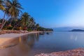 Bright colorful sunset on the tropical sea, long exposure shot, blurred water. Palm trees and sandy beach Royalty Free Stock Photo