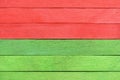 Bright colorful texture of wooden boards painted in green and red Christmas colors. Royalty Free Stock Photo