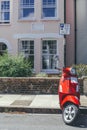 Bright colorful Vespa scooter parked on a street in London