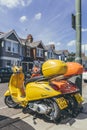 Bright colorful Vespa scooters parked on a street in London