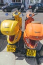 Bright colorful Vespa scooters parked on a street in London