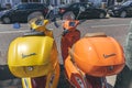 Bright colorful Vespa scooters parked on a street in London