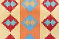 Bright colorful weaved floor mat. Ornamental carpet background. Woven texture. Ethnic pattern rug, ornaments