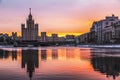 Bright colorful winter dawn on Moscow-a river with reflection in the water of the buildings of Kotelnicheskaya and Raushskaya emba Royalty Free Stock Photo