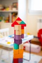 Bright colorful wooden blocks toy. Bricks building tower, castle, children`s room as a background Royalty Free Stock Photo