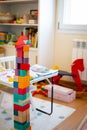 Bright colorful wooden blocks toy. Bricks building tower, castle, children`s room as a background Royalty Free Stock Photo