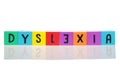 Bright colorful wooden toy blocks on a reflective surface spelling dyslexia Royalty Free Stock Photo