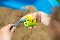 little kid is playing in sandbox with his truck toy Royalty Free Stock Photo
