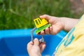 little kid is playing in sandbox with his truck toy Royalty Free Stock Photo