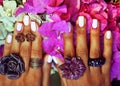 bright colorfull shot of african tanned hands with manicure amon