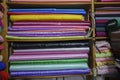 Bright colors fabric rack, pile of colorful traditional fabrics