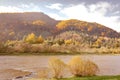 Bright colors of the forest and mountains on the banks of the river in autumn Royalty Free Stock Photo