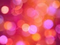 Bright coloured round blurred lights on a glowing warm red background Royalty Free Stock Photo