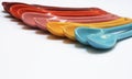 Bright coloured spoons in a row Royalty Free Stock Photo