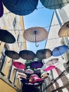 Bright coloured umbrellas as decoration in the narrow city street