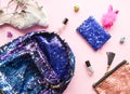 Bright composition of fashion accessories. Glitter sequins cosmetic bag, colorful bagpack, nail polishes, notepad and shoes Object Royalty Free Stock Photo