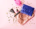 Bright composition of fashion accessories. Glitter sequins cosmetic bag, notepad and funny pen. Object on soft pastel background